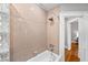 Updated bathroom showcasing a bathtub with shower head and neutral tile surround at 1545 Steele St, Denver, CO 80206