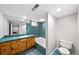 Well-lit bathroom features tile flooring, a bathtub with tiled walls, a classic vanity, and modern fixtures at 1545 Steele St, Denver, CO 80206