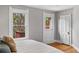 Bedroom featuring hardwood floors, two large windows, and access to private balcony at 1545 Steele St, Denver, CO 80206