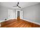 Open bedroom layout, hardwood floors, ceiling fan and white trim at 1545 Steele St, Denver, CO 80206