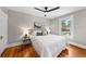 Bright bedroom featuring hardwood floors, stylish ceiling fan and a comfortable bed at 1545 Steele St, Denver, CO 80206