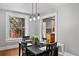 Charming dining room with a modern chandelier, hardwood floors, and natural light at 1545 Steele St, Denver, CO 80206