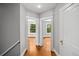 Hallway with view of hardwood floors and bright rooms with white trim at 1545 Steele St, Denver, CO 80206
