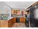 Well-equipped kitchen with wood cabinets, black appliances, and ample counter space at 1545 Steele St, Denver, CO 80206