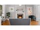 Inviting living room with a cozy fireplace, stylish decor, and hardwood flooring at 1545 Steele St, Denver, CO 80206