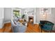 Cozy living room featuring a fireplace, comfortable seating, and beautiful hardwood floors at 1545 Steele St, Denver, CO 80206