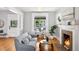 Bright living room features hardwood floors, a cozy fireplace, and large windows at 1545 Steele St, Denver, CO 80206