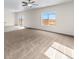 A well-lit living room boasts plush carpeting, and a view of the fenced backyard at 7211 Dolores Ave, Frederick, CO 80530