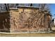 Stone mural depicting a historic train scene with figures, set on an exterior wall with detailed craftsmanship at 7211 Dolores Ave, Frederick, CO 80530