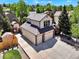 Aerial view of a two-story house boasting a large driveway and an exterior storage unit at 2957 W Rowland Ave, Littleton, CO 80120
