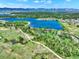 Scenic aerial view of a lake surrounded by lush greenery and distant mountains at 2957 W Rowland Ave, Littleton, CO 80120