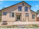 Spacious backyard featuring a patio, firepit, and convenient access from sliding glass doors and a side entrance at 2957 W Rowland Ave, Littleton, CO 80120