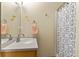 Clean bathroom with a single sink, a mirror, a shower/tub combo, and a patterned shower curtain at 2957 W Rowland Ave, Littleton, CO 80120