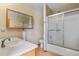 Bathroom featuring a vanity and shower with sliding glass doors at 2957 W Rowland Ave, Littleton, CO 80120