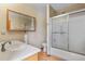 Bathroom with a shower over tub, a vanity with sink, and a mirrored medicine cabinet at 2957 W Rowland Ave, Littleton, CO 80120