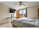 Bedroom featuring a ceiling fan, TV and large window with a view at 2957 W Rowland Ave, Littleton, CO 80120