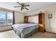 Bedroom featuring a ceiling fan, built-in headboard shelving, and natural light at 2957 W Rowland Ave, Littleton, CO 80120