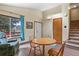 Bright dining area with wood floors, a table with chairs, and easy access to the staircase at 2957 W Rowland Ave, Littleton, CO 80120