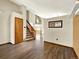 Entryway features wood flooring, a staircase, and a view into the home's open floor plan at 2957 W Rowland Ave, Littleton, CO 80120