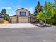 Charming two-story home with a three-car garage, well-maintained landscaping, and a welcoming front porch at 2957 W Rowland Ave, Littleton, CO 80120
