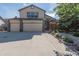 Charming two-story home boasts a spacious driveway, attached 2-car garage and mature front yard at 2957 W Rowland Ave, Littleton, CO 80120