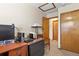 Functional home office setup with natural wood trim, ample workspace, and closet for organization at 2957 W Rowland Ave, Littleton, CO 80120