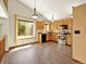 Bright kitchen featuring stainless steel appliances, wooden cabinets, and a dining area with a large window at 2957 W Rowland Ave, Littleton, CO 80120
