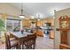 Functional kitchen space featuring wood cabinets, stainless steel appliances, and a cozy dining area at 2957 W Rowland Ave, Littleton, CO 80120