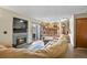 Open-concept living room featuring a fireplace, sliding door, and access to the kitchen at 2957 W Rowland Ave, Littleton, CO 80120