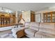 Comfortable living room with a large sofa, staircase, and wooden accents at 2957 W Rowland Ave, Littleton, CO 80120