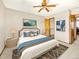 Cozy bedroom featuring a large bed with stylish decor, a ceiling fan, and closet access at 2957 W Rowland Ave, Littleton, CO 80120