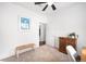 Bright bedroom with hardwood floors and a bench at 6723 S Winnipeg Cir # 104, Aurora, CO 80016