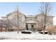 Front view of townhome, showcasing architectural details and winter setting at 6723 S Winnipeg Cir # 104, Aurora, CO 80016