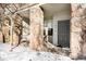 Inviting entryway with stone columns and a gray front door at 6723 S Winnipeg Cir # 104, Aurora, CO 80016