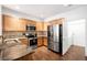 Well-equipped kitchen featuring granite countertops and wood cabinets at 6723 S Winnipeg Cir # 104, Aurora, CO 80016