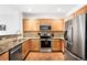 Modern kitchen with stainless steel appliances and granite countertops at 6723 S Winnipeg Cir # 104, Aurora, CO 80016