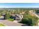 A high angle shows a single-story home with mature landscaping and mountain views at 228 Emerald Ct, Castle Rock, CO 80104