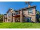 Backyard exterior view featuring a patio, balcony, and expansive lawn at 228 Emerald Ct, Castle Rock, CO 80104