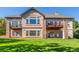 Backyard exterior view featuring a patio area with furniture and a well-maintained lawn at 228 Emerald Ct, Castle Rock, CO 80104