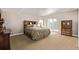 Bright bedroom featuring a wooden headboard, carpeted floors, and sliding glass doors at 228 Emerald Ct, Castle Rock, CO 80104