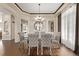 Dining room features a glass table, upholstered chairs, hardwood floors, and view of a mirror wall feature at 228 Emerald Ct, Castle Rock, CO 80104