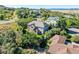 An elevated view of a spacious two-story house showcasing the lush green yard and surrounding mature trees at 228 Emerald Ct, Castle Rock, CO 80104