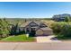 Sprawling single-story home with mature landscaping, a two-car garage, and views of the surrounding valley at 228 Emerald Ct, Castle Rock, CO 80104