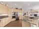 Open kitchen features stainless steel appliances, custom cabinets and beautiful granite countertops at 228 Emerald Ct, Castle Rock, CO 80104