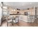 Kitchen with stainless steel appliances, stone countertops, and a large adjacent breakfast nook at 228 Emerald Ct, Castle Rock, CO 80104