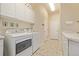 Well lit laundry room with overhead cabinets and sink at 228 Emerald Ct, Castle Rock, CO 80104