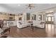 Open floor plan living room with hardwood floors, plenty of seating, and seamless transition to kitchen and dining areas at 228 Emerald Ct, Castle Rock, CO 80104