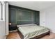 This bedroom features an elegant dark green accent wall and a comfortable queen bed at 579 Wright St # 204, Lakewood, CO 80228
