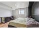 Cozy bedroom features a desk and natural light from a large window at 579 Wright St # 204, Lakewood, CO 80228