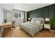 Bright bedroom with green accent wall, desk, and natural light from a large window at 579 Wright St # 204, Lakewood, CO 80228